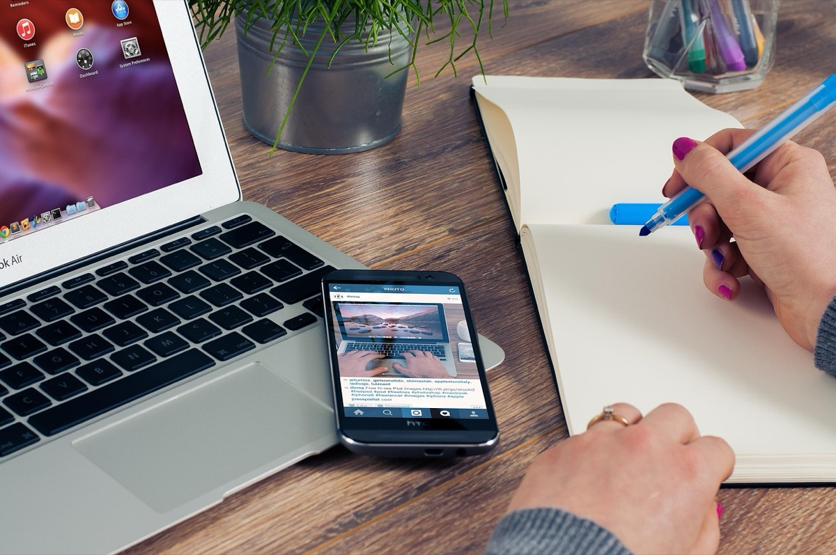Tech reviewer with laptop and smartphone