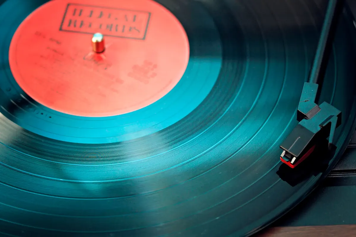 A detailed close-up view of a vintage vinyl record spinning on a turntable, capturing its nostalgic beauty.